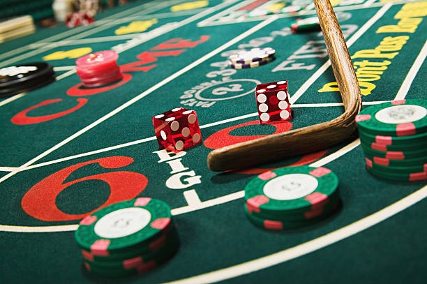 Live dealer rolling dice at a Sic Bo table in a professional studio
